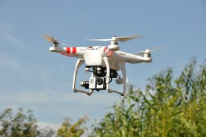 small white drone with camera